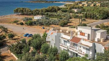 Un quartier résidentiel en bord de mer, avec des immeubles modernes, une plage et une vue dégagée sur la mer.