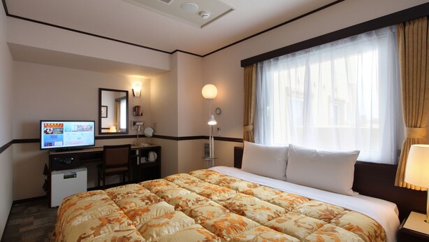A hotel room with a large bed, a desk with a computer, a television, and a window with curtains. - Toyoko Inn Tokyo Tozai Line Nishikasai (Tokyo)