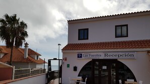 A reception area with a tiled floor, white walls, and a sign that reads 'Las Fuentes Recepción'. - Las Fuentes (Arona)