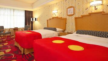 A hotel room with two beds, a desk, a chair, and a large window with curtains.