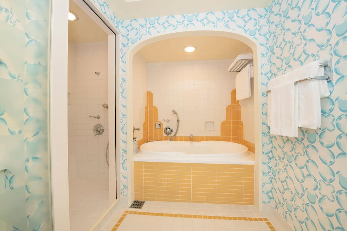 separate bathtub and shower, hair dryer, slippers, electronic bidet