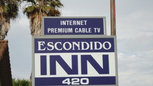 A sign for Escondido Inn, indicating it offers premium cable TV and is located at 420. - Escondido Inn (Escondido)
