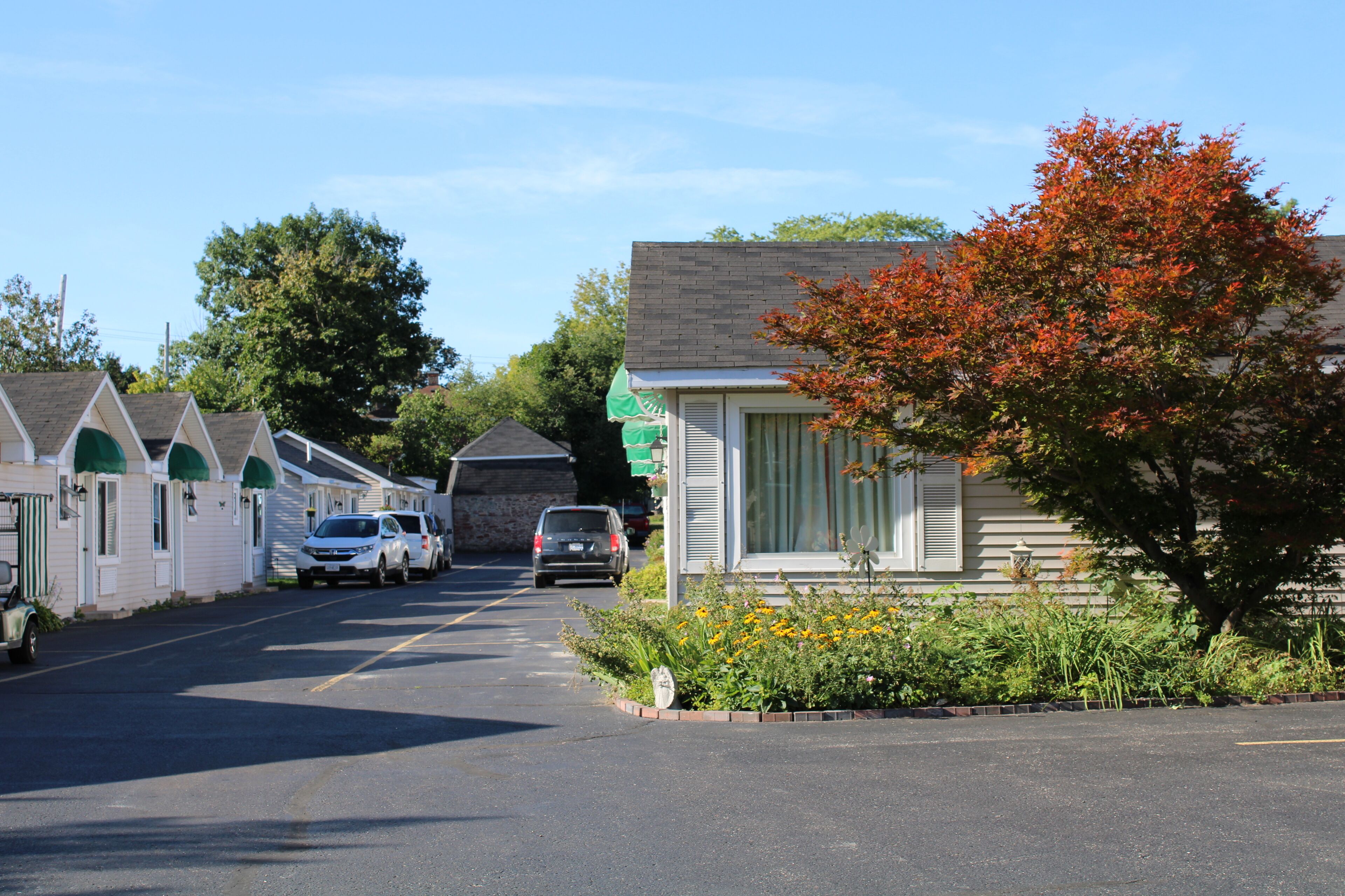 A row of single-story buildings with a central road, likely a motel or small hotel.