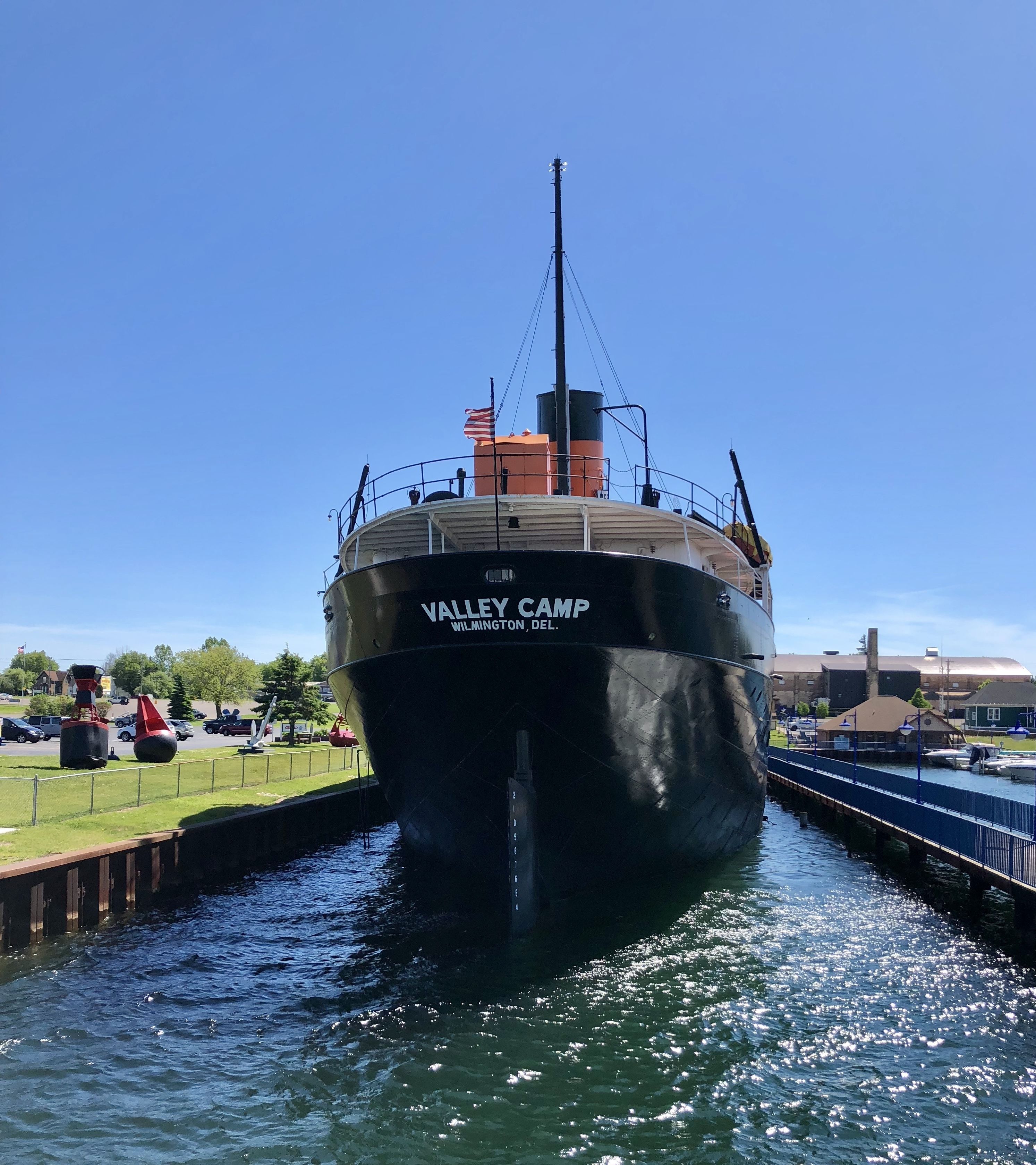 A large ship named 'Valley Camp' docked at a marina.