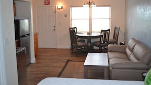 A compact living space with a kitchenette, dining area, and seating area. - Knight's Key Suites (Marathon)