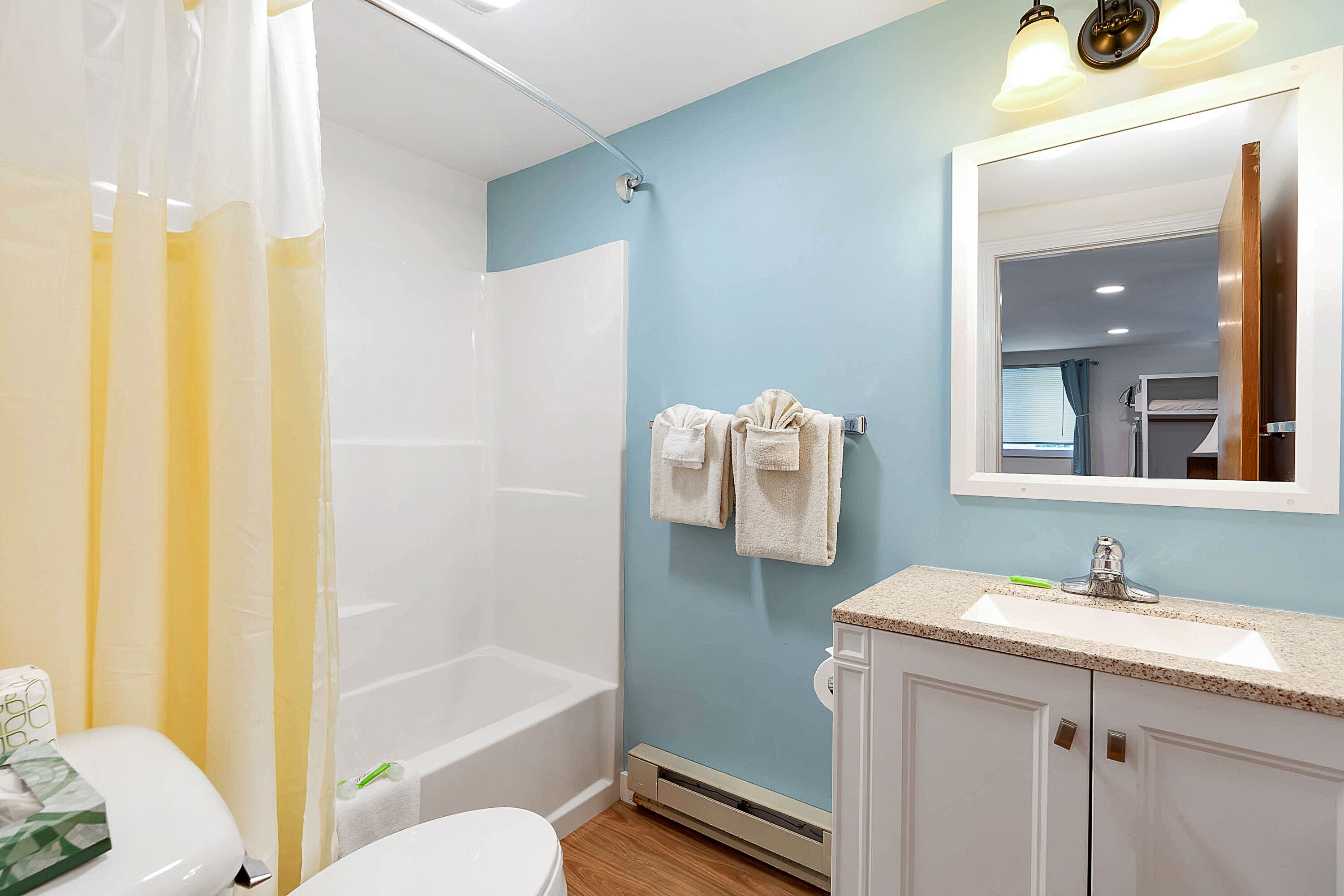 A bathroom with a bathtub, toilet, and sink.