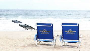 Relax on the beach with access to the ocean and a staircase leading down to the water.
