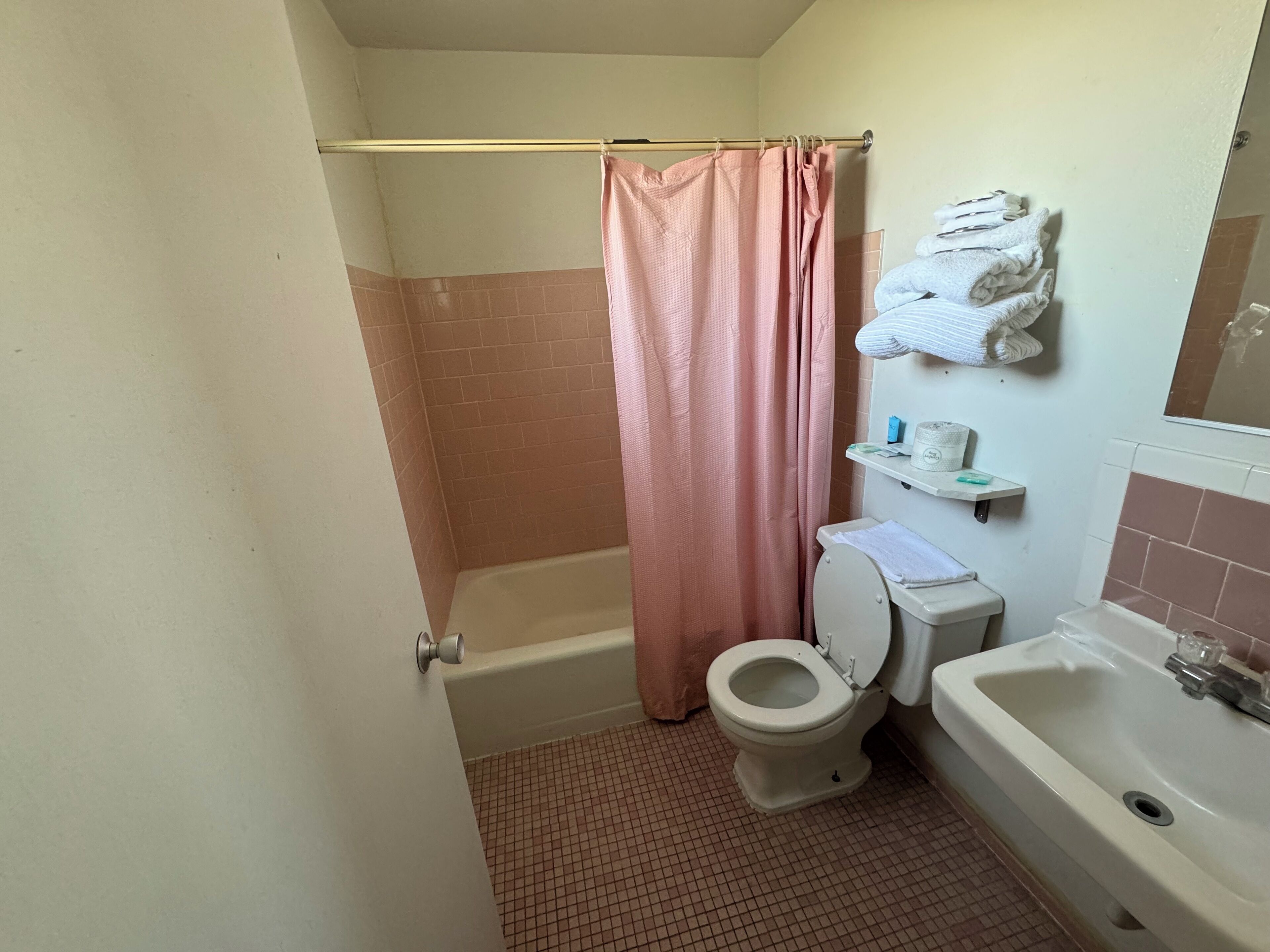 A bathroom with a bathtub, toilet, and sink.