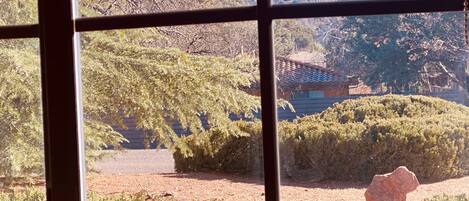 A window with a view of a mountainous landscape and a sign that reads "good vibes only".
