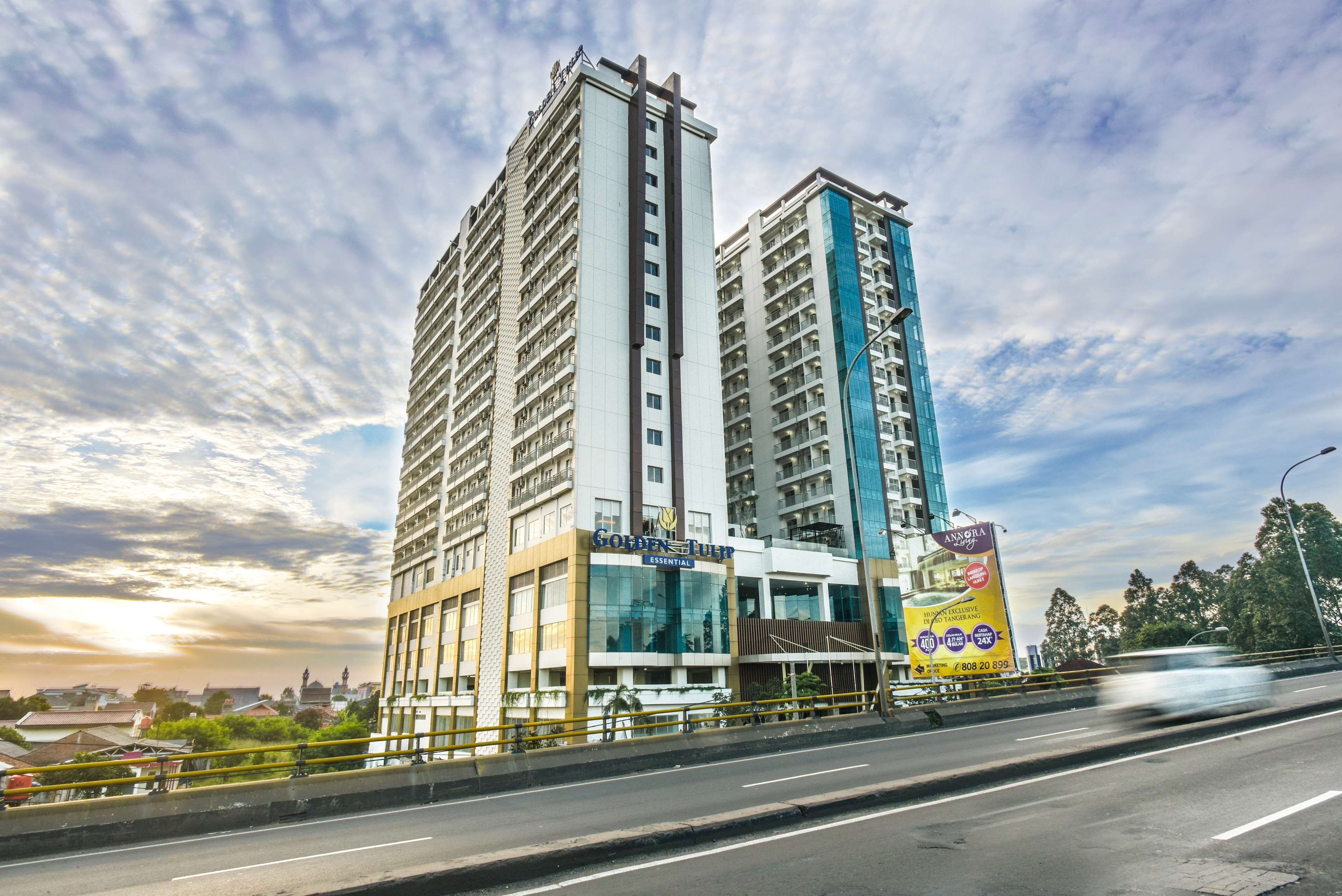 A high-rise hotel with multiple floors, a prominent sign for 'Golden Tulip', and a large advertisement for 'Anagra'.
