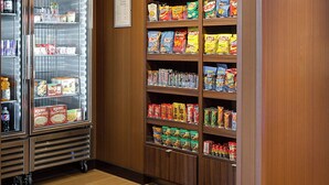 A corner market with refrigerated display cases and shelves stocked with snacks and beverages. - Fairfield Inn & Suites Dallas West/i-30 (Dallas)