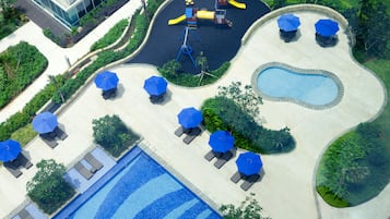 Relax by the pool surrounded by lounge chairs and umbrellas, or let kids enjoy the adjacent play area with a slide and climbing structures.