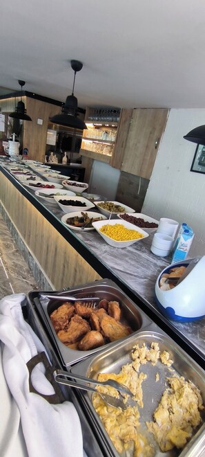 A buffet with various food items and utensils. - Romeo Beach Hotel (Kemer)