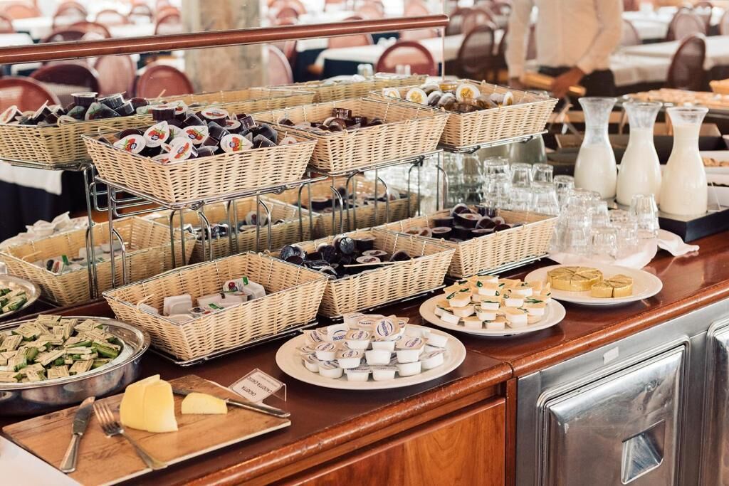 A buffet with various food items and beverages.