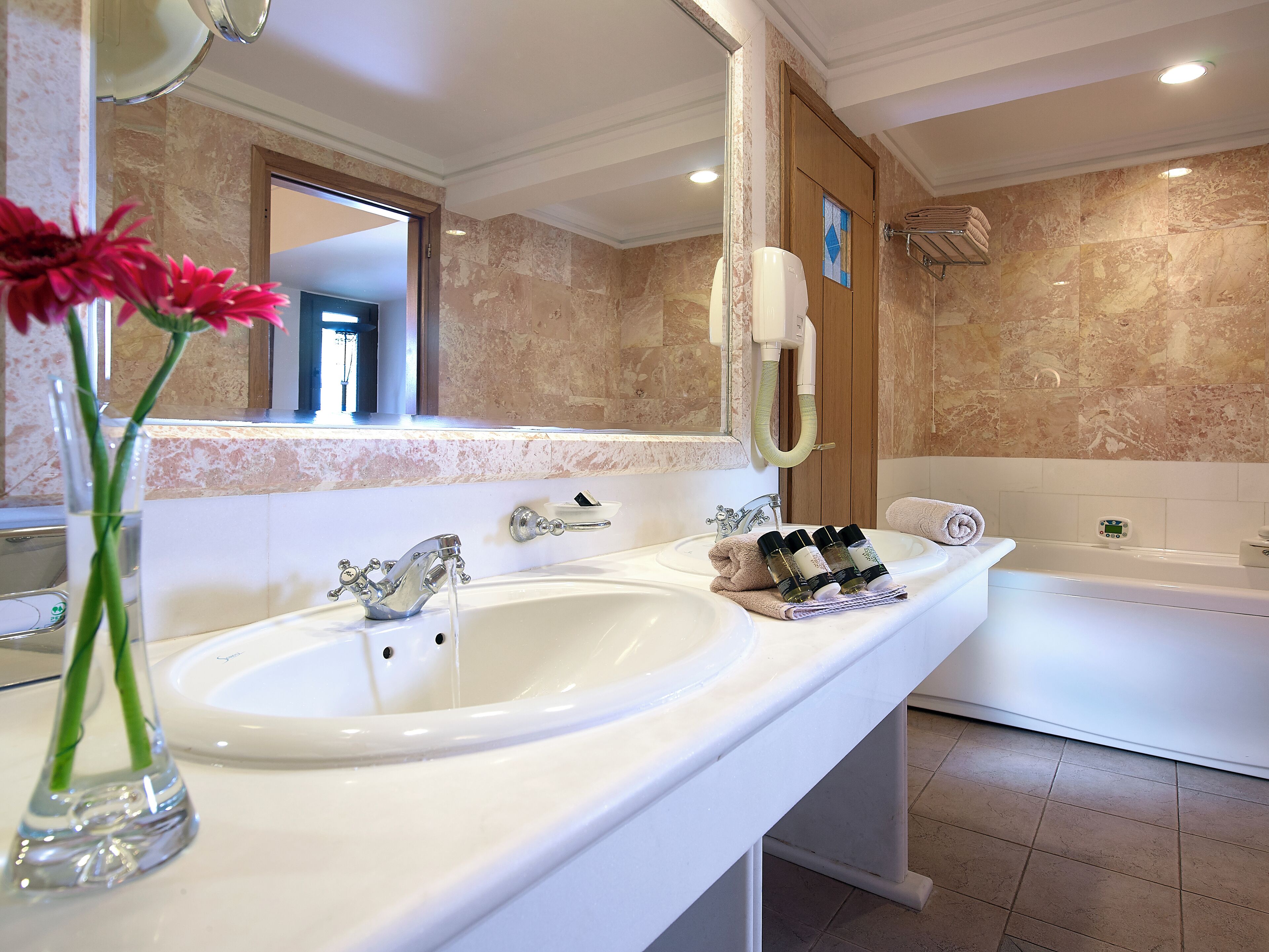 knossos suite sharing pool | bathroom | bathtub, free toiletries, hair dryer, slippers