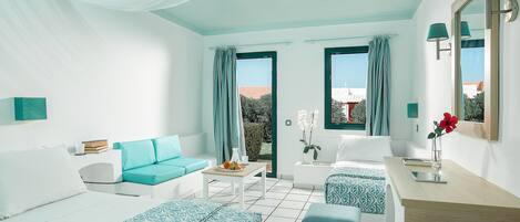 A modern hotel room with two beds, a sofa, a desk, and a view of the outdoors.