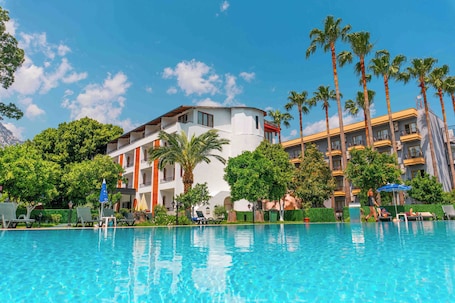 Seasonal outdoor pool, open 8 AM to 6:30 PM, pool umbrellas. Belpoint Beach Hotel
