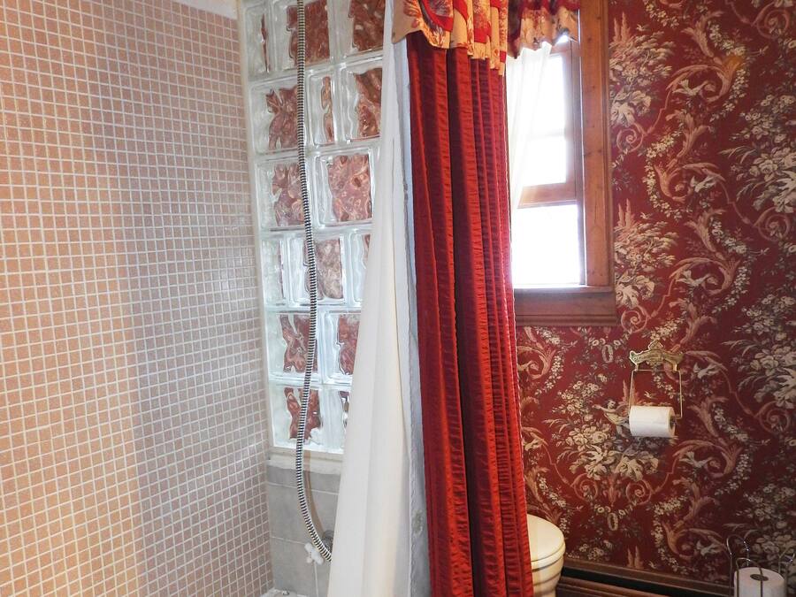 A bathroom with a bathtub, a shower, and a toilet.