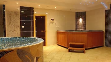 Bathroom features a large bathtub and a vanity for grooming.
