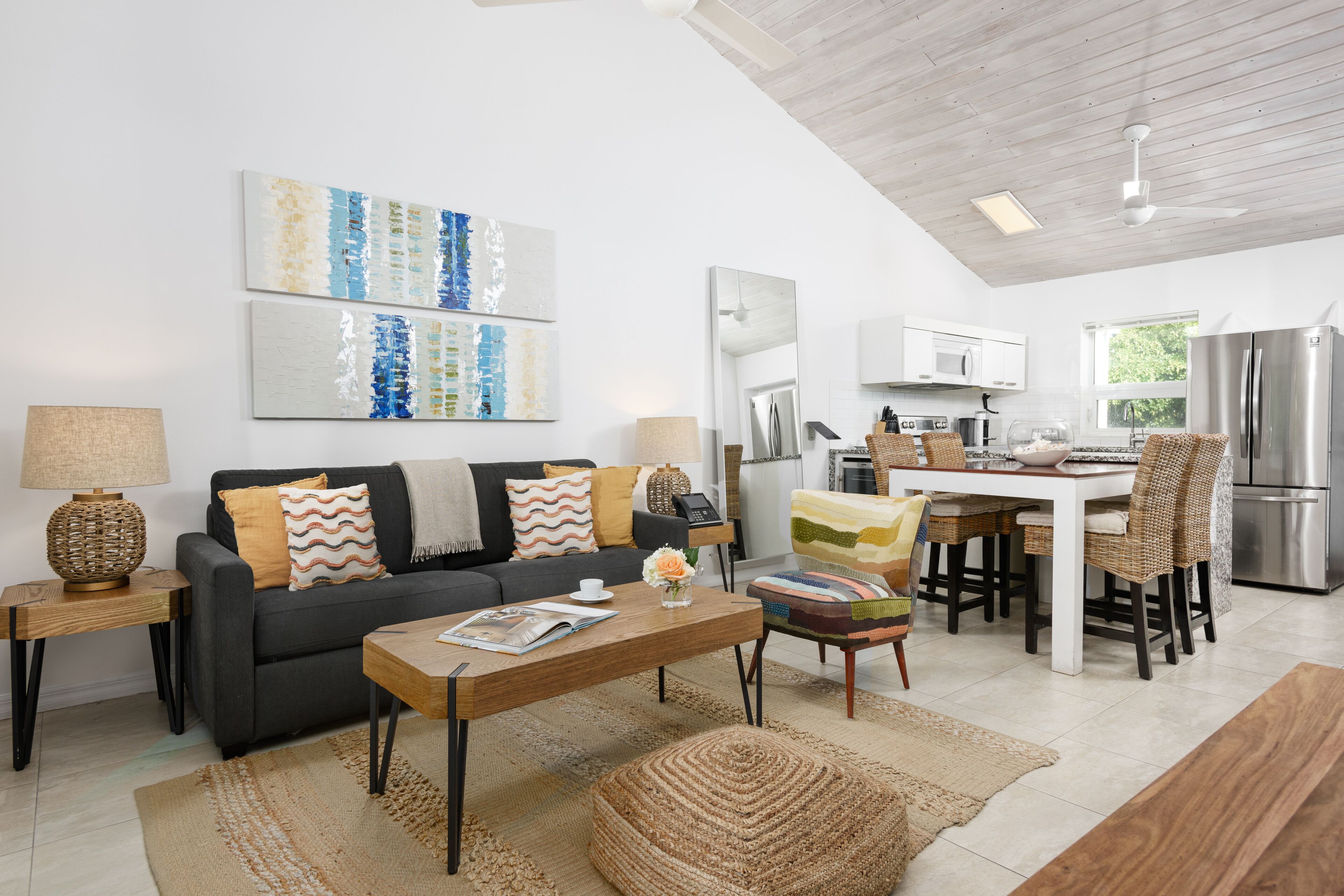 A modern living room with a sofa, coffee table, and artwork on the wall.