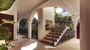 A grand staircase with a balustrade, leading to an upper level. - Fabiola Condo Hotel (Playa del Carmen)