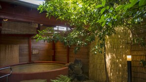 A traditional Japanese-style room with tatami flooring, a wooden ceiling, and a bamboo wall. - Suzuya Konnichiro (Kaga)