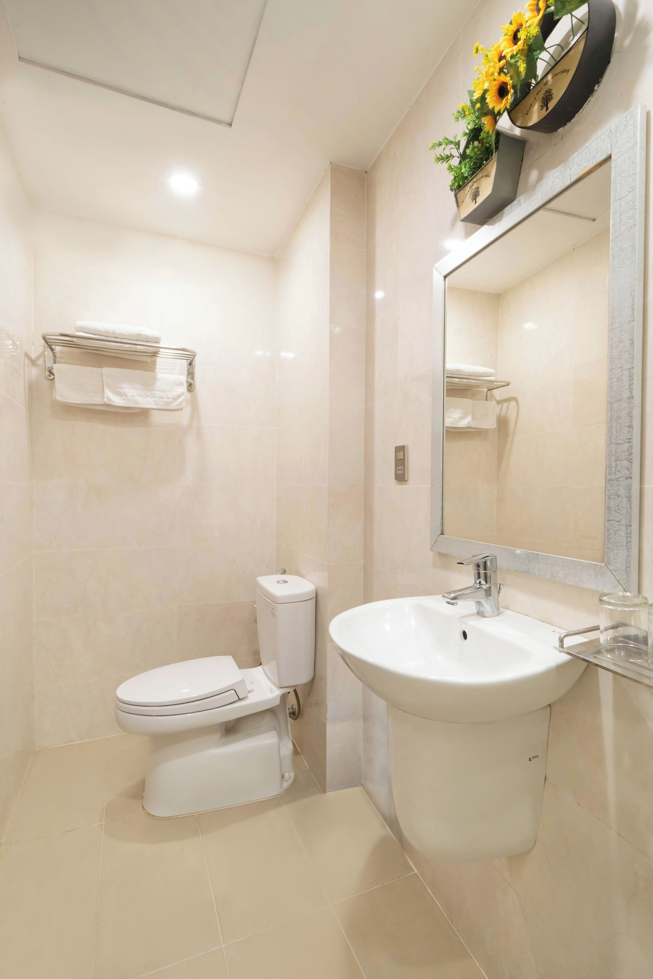 A modern bathroom with a toilet, sink, and mirror.