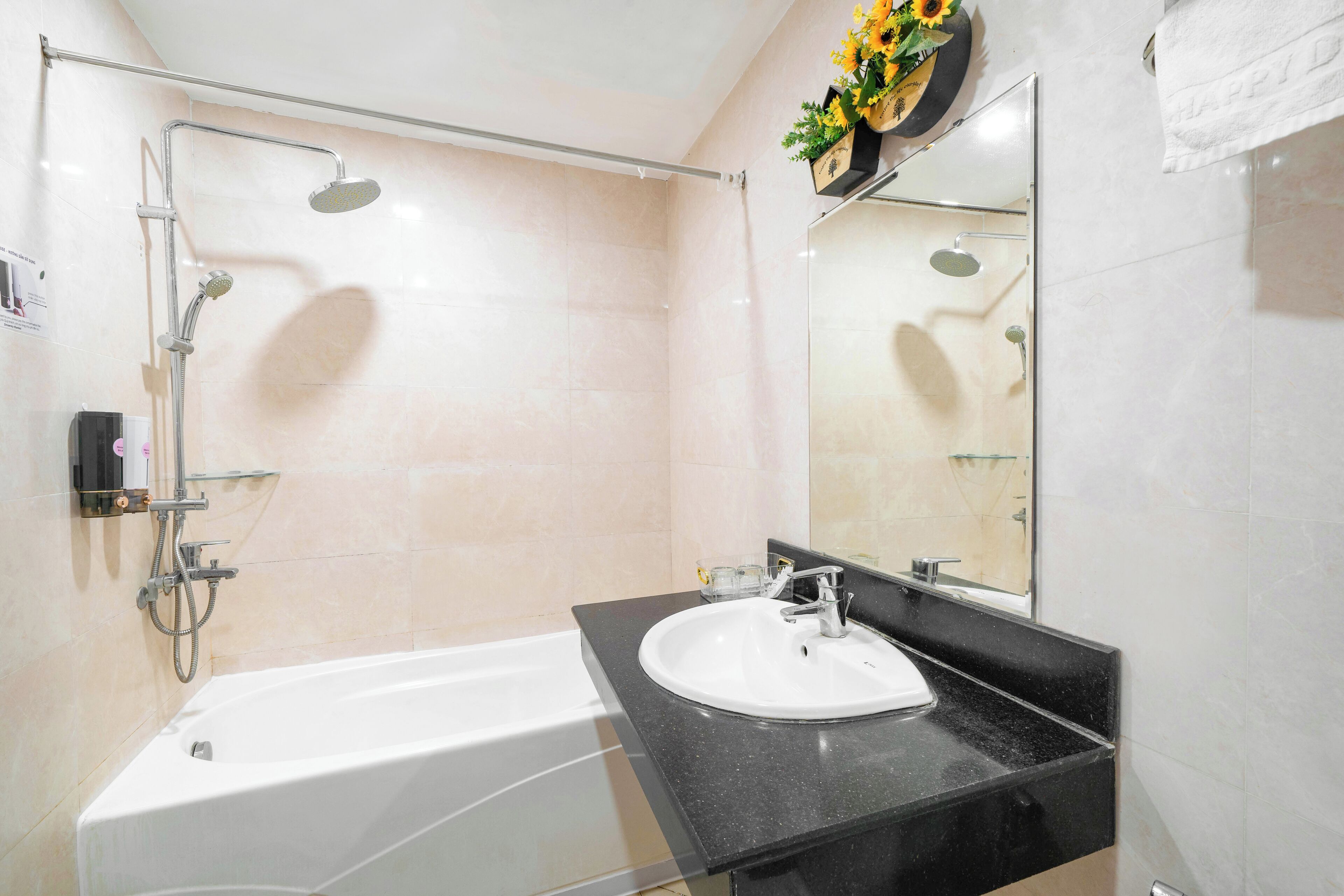 A modern bathroom with a bathtub, a sink, and a shower.