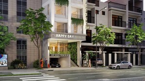 A multi-story hotel with balconies, a visible entrance, and a sign indicating a spa service. - Happy Day Riverside Hotel & Spa Danang (Da Nang)