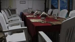 A conference room with a long table set for a meeting.