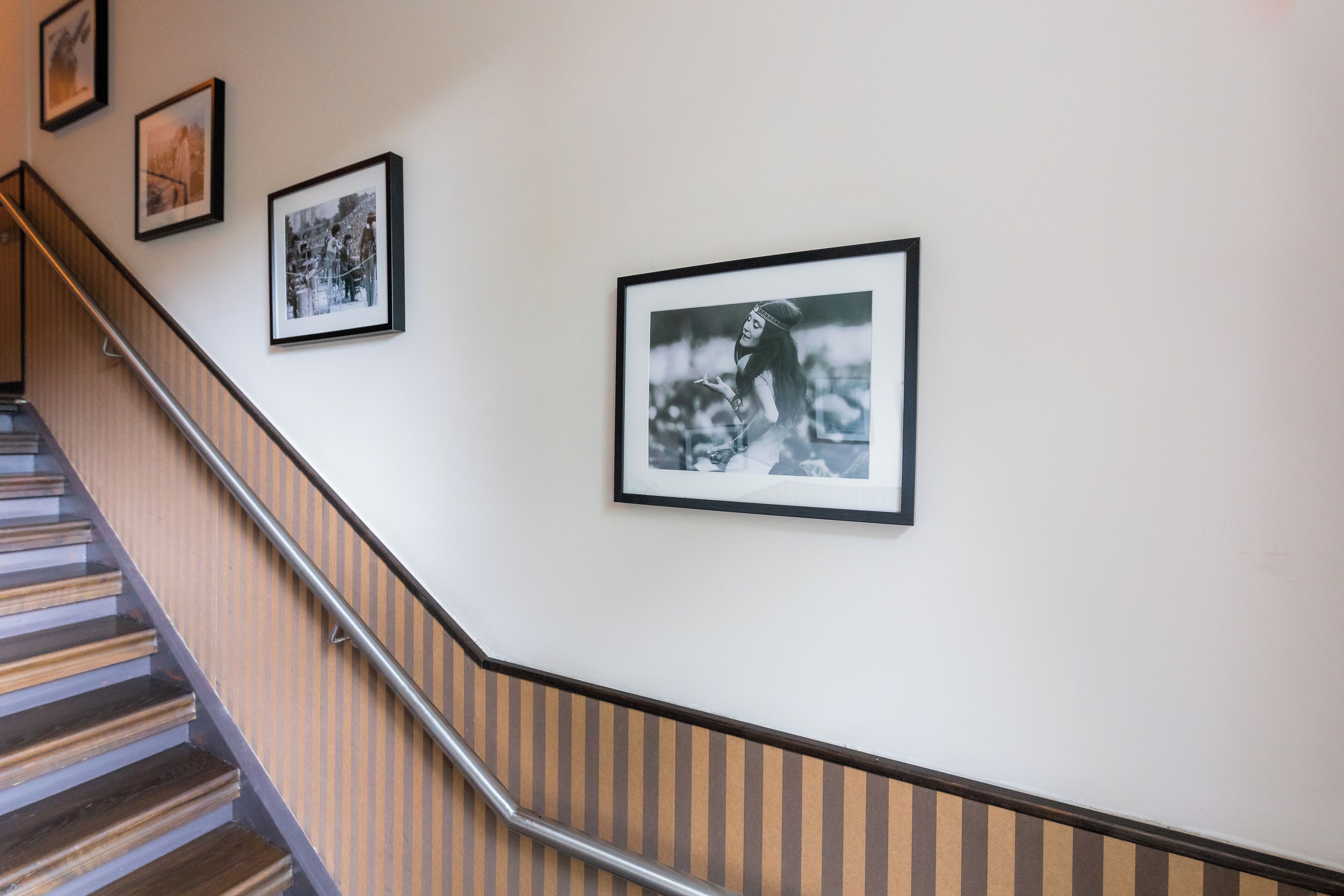 A staircase with a metal handrail and wooden steps.