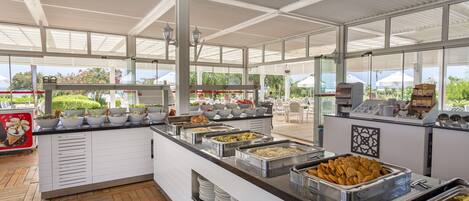 A buffet with various food options and a view of the outdoors.