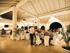 A spacious indoor dining area with high ceilings and white columns, featuring round tables and chairs. - Royal Villa by Island Villas (Westmoreland)