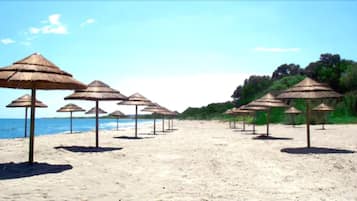 On the beach, sun-loungers, beach umbrellas, beach towels