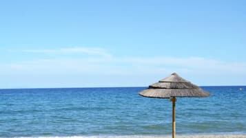 On the beach, sun-loungers, beach umbrellas, beach towels