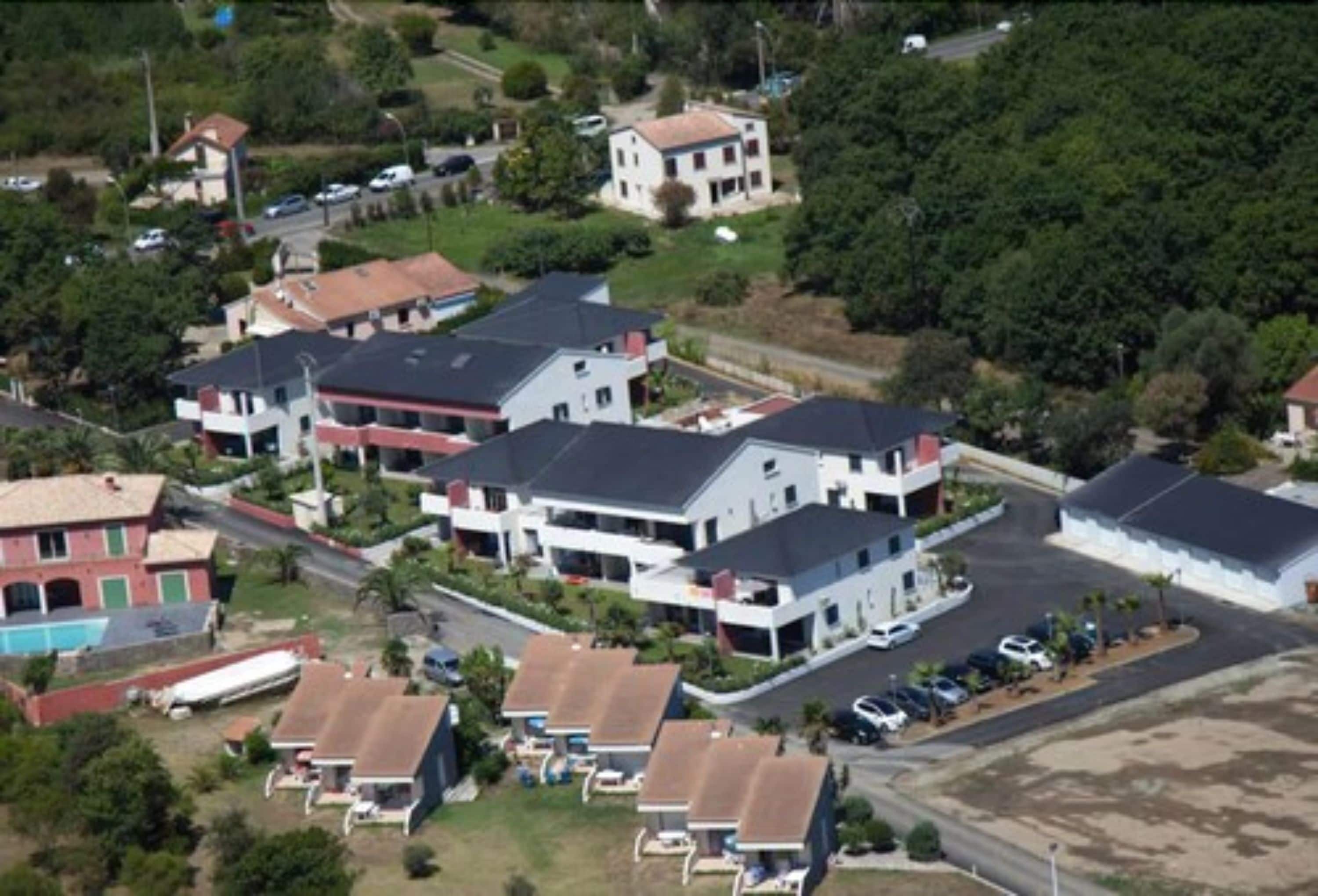 A residential area with multiple two-story houses, some with attached garages, and a few with visible balconies.