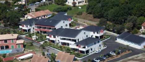A residential area with multiple two-story houses, some with attached garages, and a few with visible balconies.