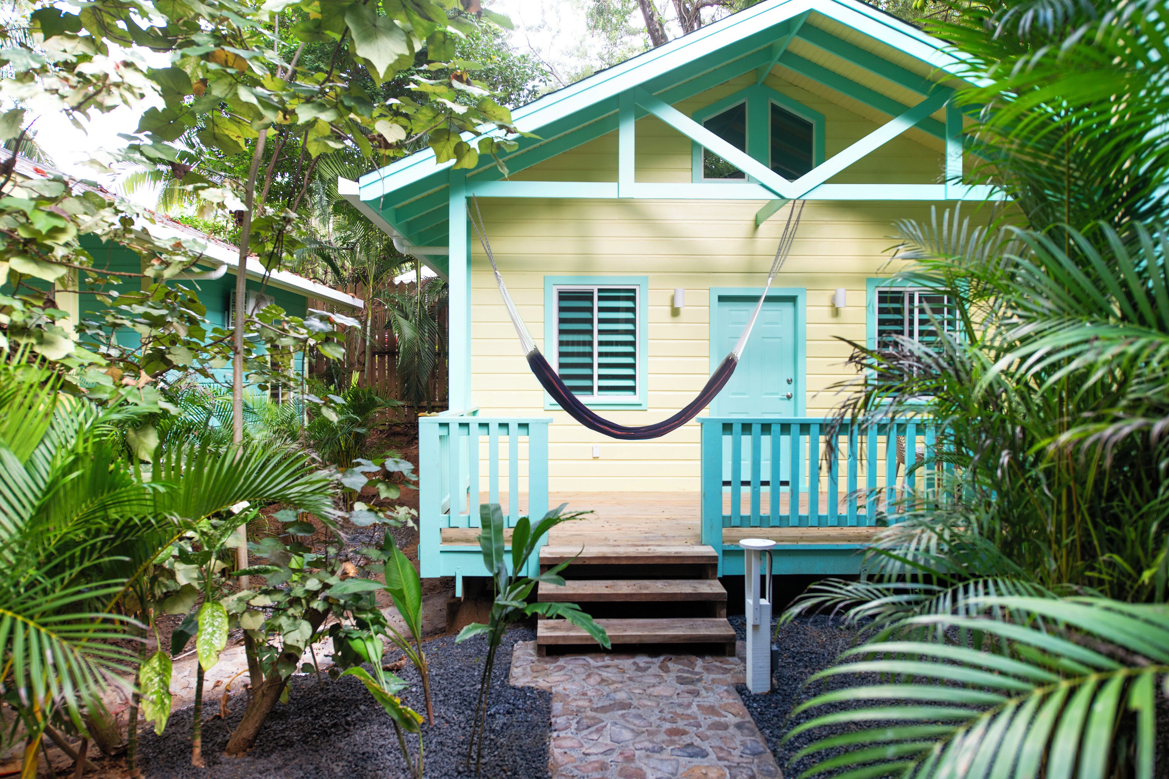 A house with a porch, steps, and a hammock.