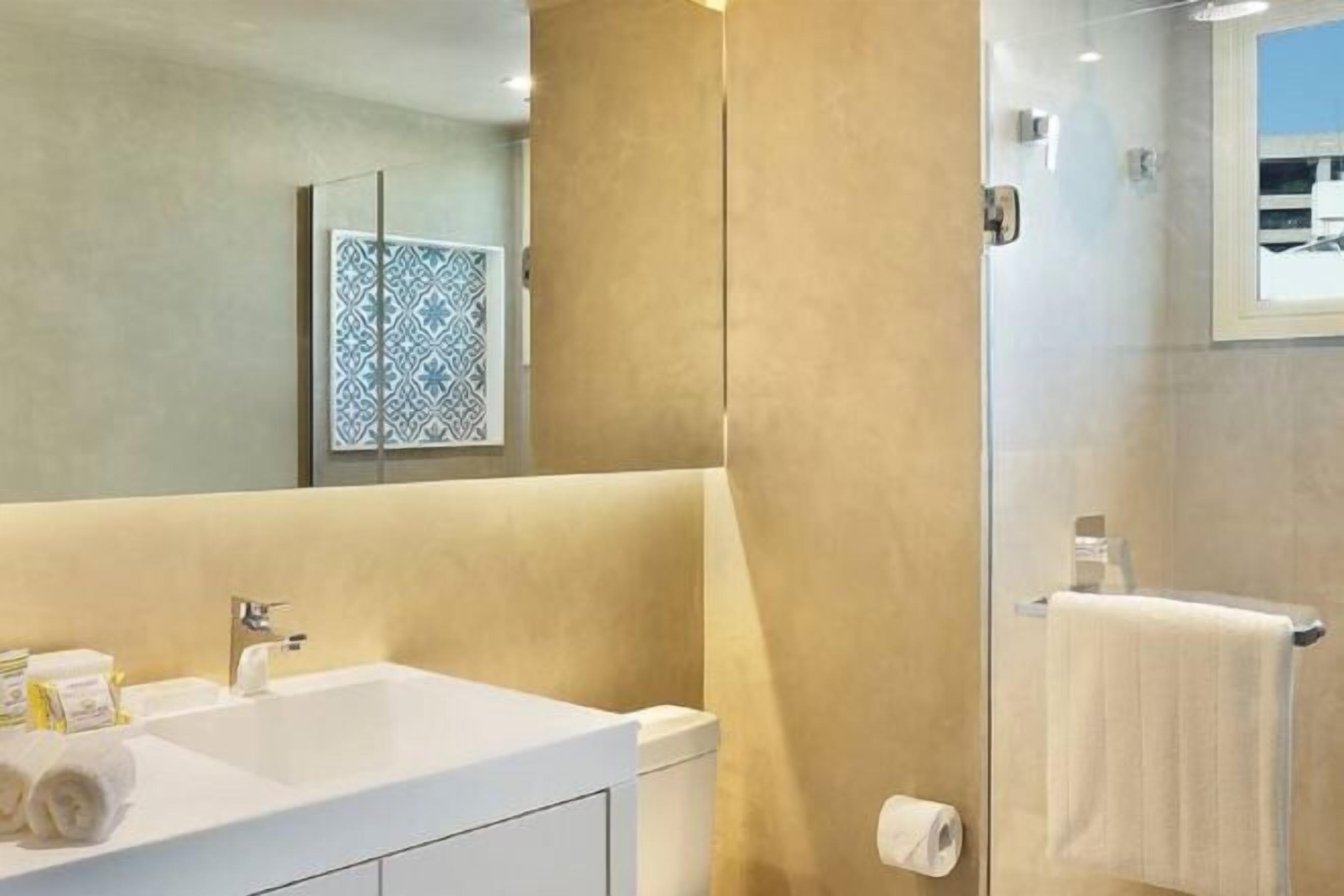 Designer toiletries, hair dryer, towels