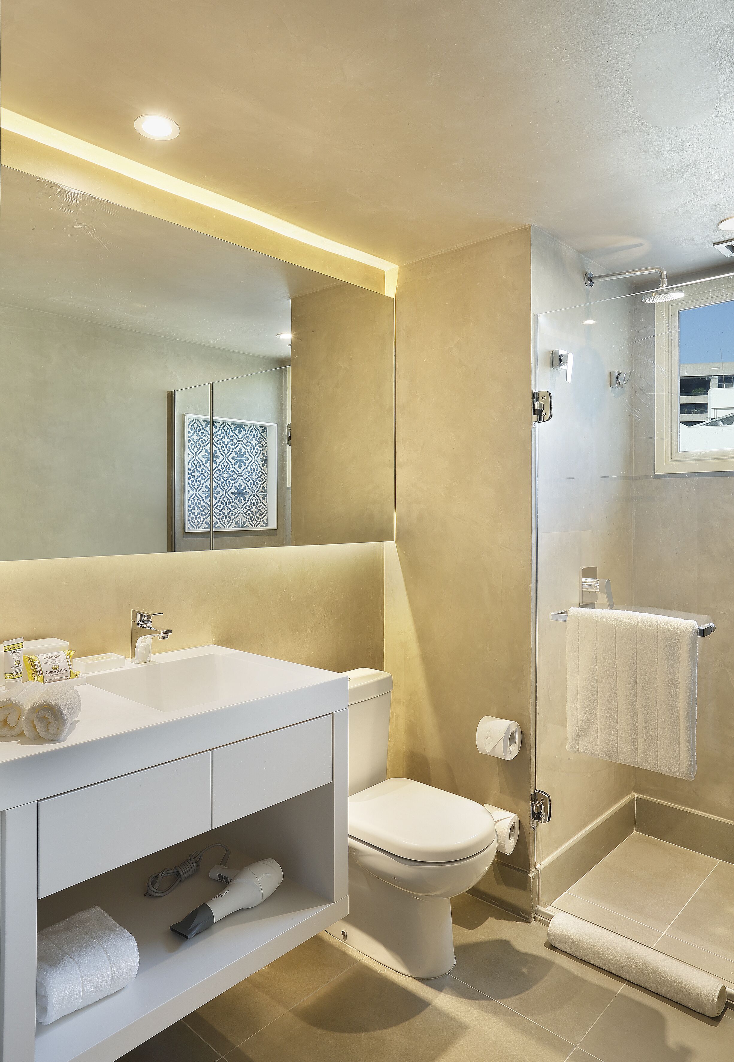 designer toiletries, hair dryer, towels