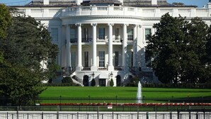 A large, white building with a symmetrical facade, multiple columns, and a central entrance. - The Poppy Georgetown (Washington)