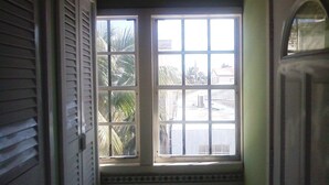 A hallway with a window overlooking a street.