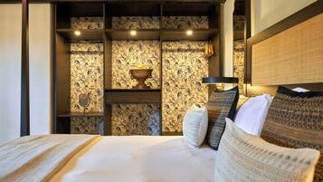 Una habitación de hotel con una cama, una mesita de noche, una lámpara y un cuenco decorativo en la pared.