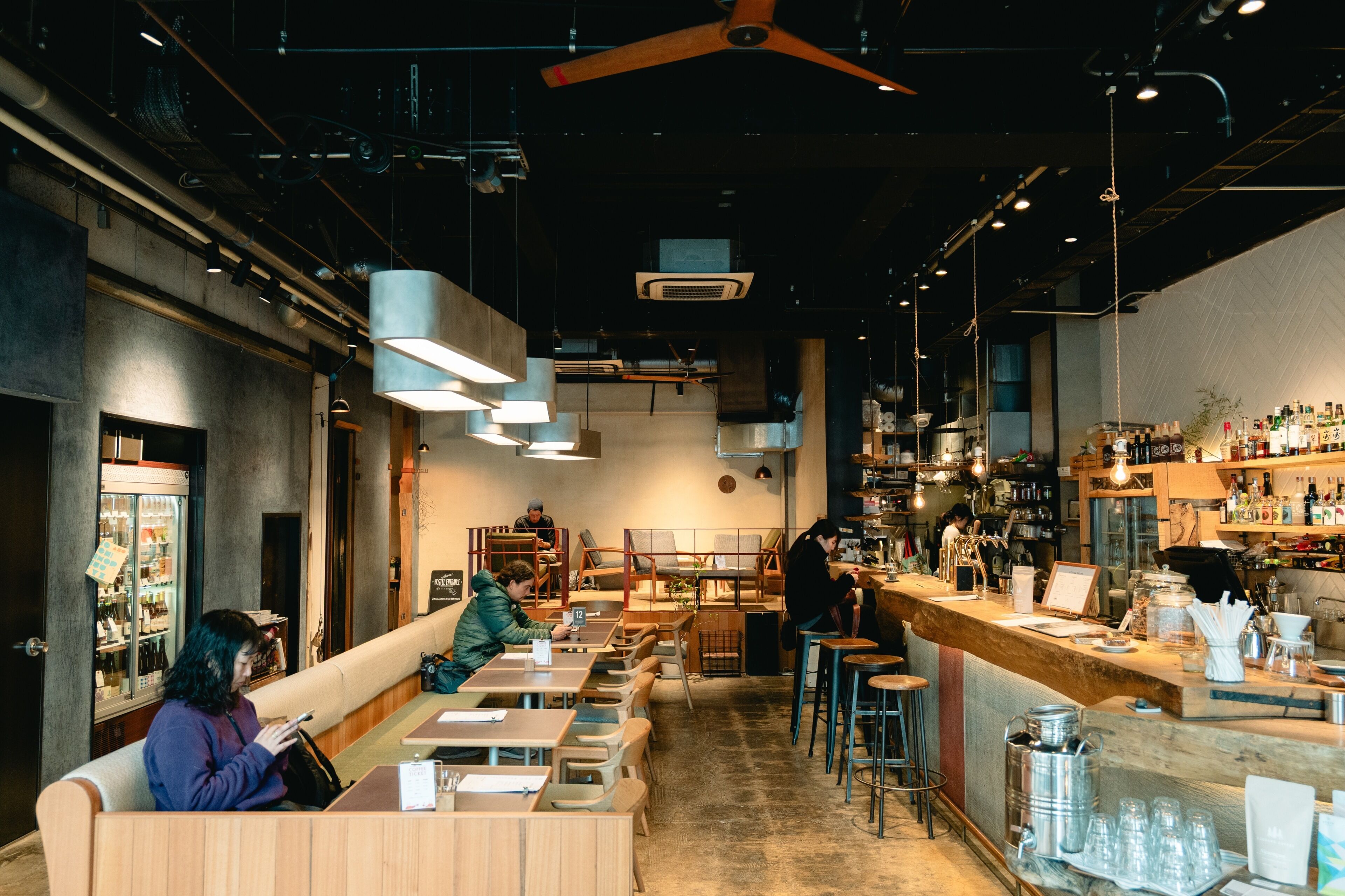 A restaurant interior with booths, a bar area, and a counter.