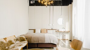 A modern bedroom with a large bed, a round mirror, a wooden chair, and a small table. - Len KYOTO KAWARAMACHI – Hostel (Kyoto)