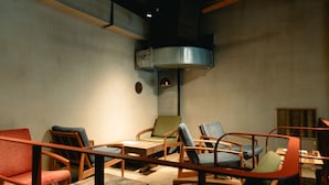 A room with multiple seating areas, a ceiling fan, and a built-in oven. - Len KYOTO KAWARAMACHI – Hostel (Kyoto)