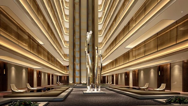 A modern hotel lobby with a central sculpture, multiple seating areas, and a high ceiling with linear lighting. - Wyndham Grand Plaza Royale Huayu Chongqing (Chongqing)