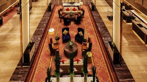 A spacious lobby with a central seating area, high ceilings, and a decorative ceiling light. - Wyndham Grand Plaza Royale Huayu Chongqing (Chongqing)