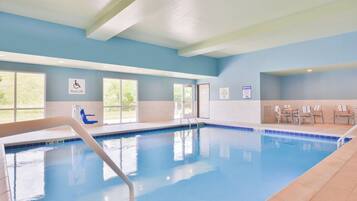 A swimming pool with a pool lift, lounge chairs, and a 'No Diving Allowed' sign.