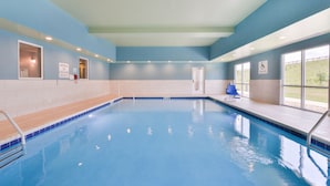 An indoor swimming pool with clear blue water, a lifeguard station, and a pool lift. - Holiday Inn Express & Suites Salem by IHG (Salem)